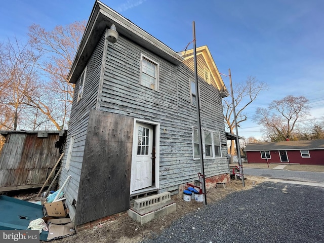 exterior space featuring entry steps and fence