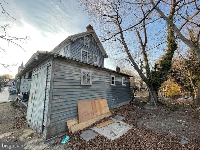 view of property exterior with a chimney