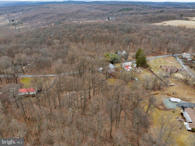 birds eye view of property with a wooded view