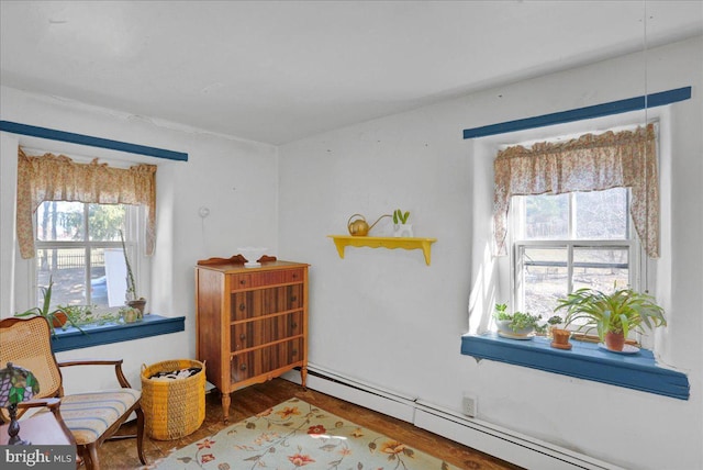 sitting room featuring wood finished floors and a baseboard radiator