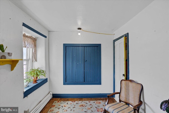 living area featuring baseboard heating