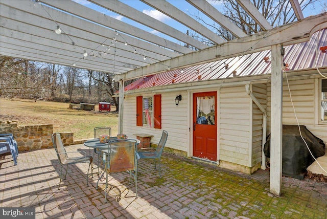 view of patio with area for grilling, a pergola, and outdoor dining area