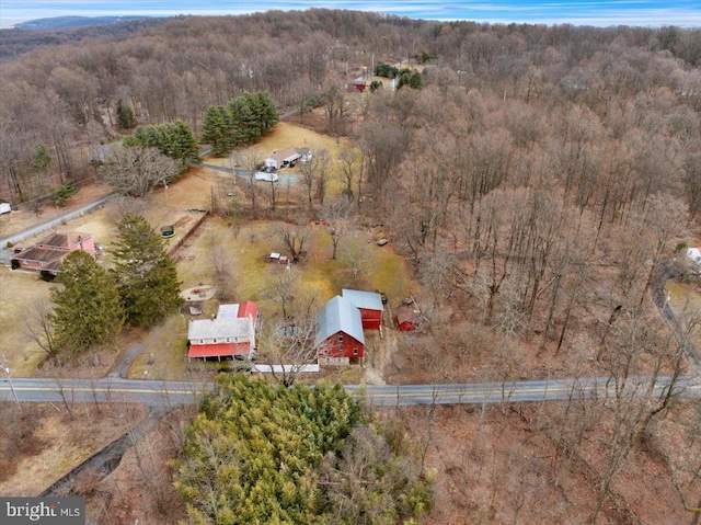 drone / aerial view with a wooded view