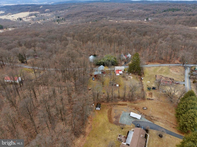 birds eye view of property featuring a wooded view