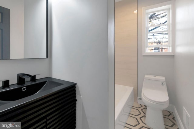 1354 Talbert Ter SE, Washington, DC 20020 - bathroom featuring toilet, a bathtub, vanity, tile patterned floors, and baseboards