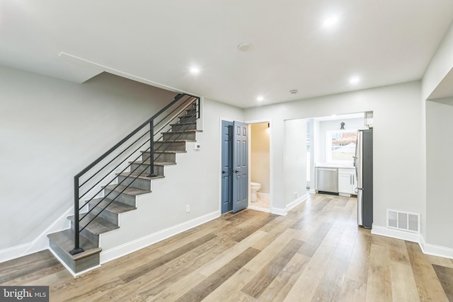 1354 Talbert Ter SE, Washington, DC 20020 - unfurnished living room with stairway, light wood finished floors, baseboards, and recessed lighting