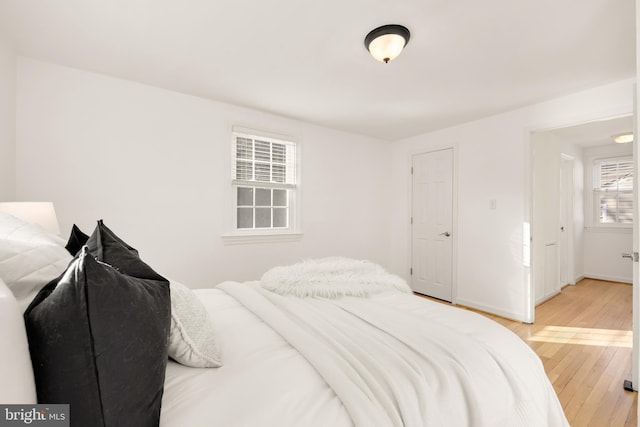 bedroom with light wood-style floors and baseboards