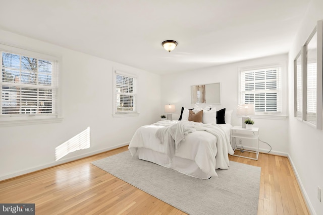 bedroom featuring light wood-type flooring and baseboards