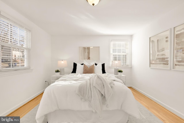 bedroom featuring baseboards and wood finished floors