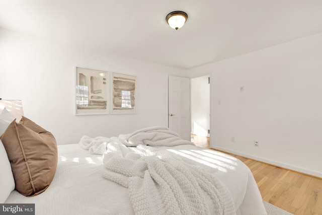 bedroom featuring baseboards and wood finished floors