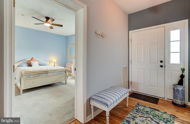 entrance foyer with a textured ceiling, ceiling fan, and visible vents