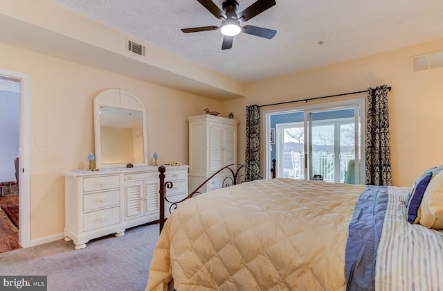 bedroom with access to exterior, visible vents, a textured ceiling, and light colored carpet