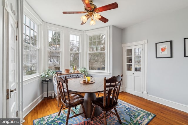 sunroom / solarium featuring ceiling fan