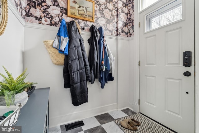 mudroom featuring wainscoting, visible vents, and wallpapered walls