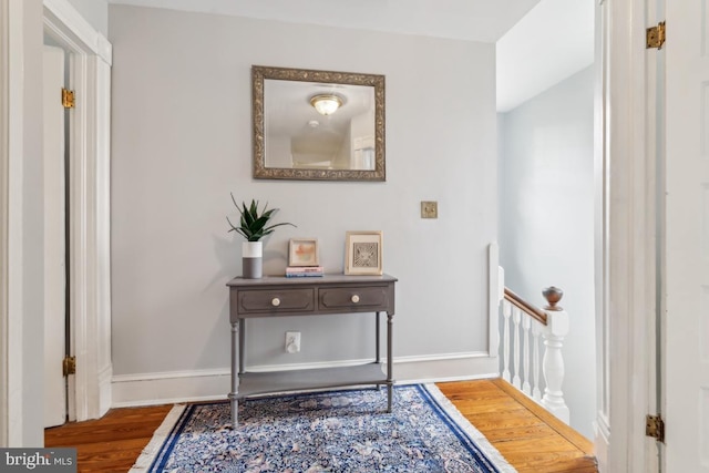 corridor featuring wood finished floors and baseboards