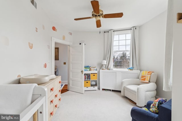 bedroom featuring carpet floors, visible vents, ceiling fan, and radiator heating unit