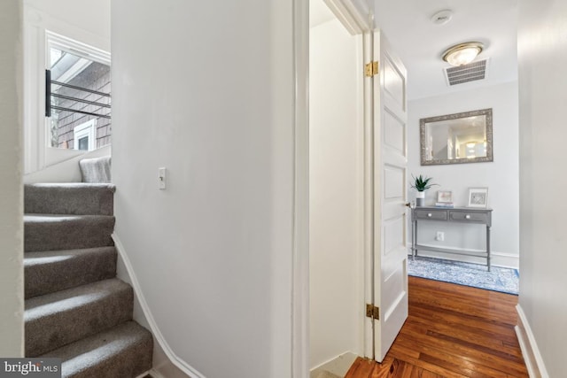 interior space with wood finished floors, visible vents, and baseboards