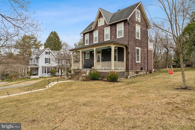 view of front facade with covered porch and a front lawn