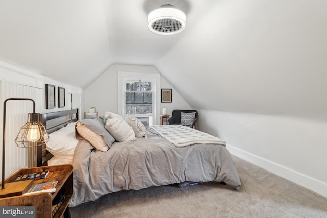 bedroom with lofted ceiling, carpet floors, and baseboards