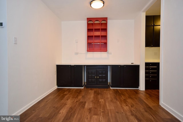 bar featuring dark wood-style floors and baseboards