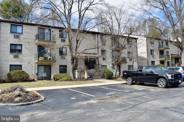 view of property featuring uncovered parking