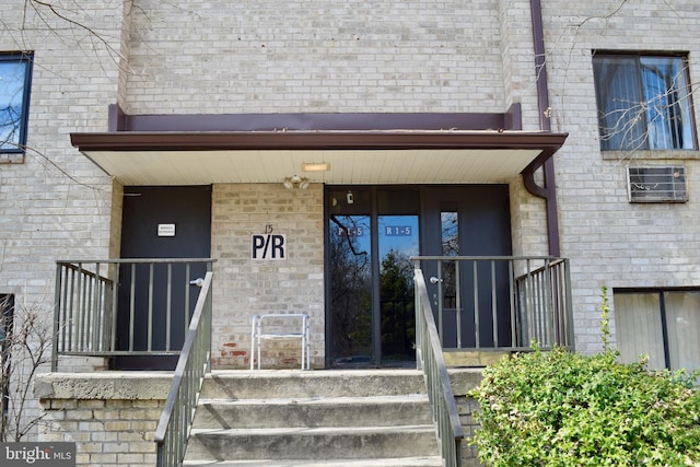 property entrance featuring brick siding