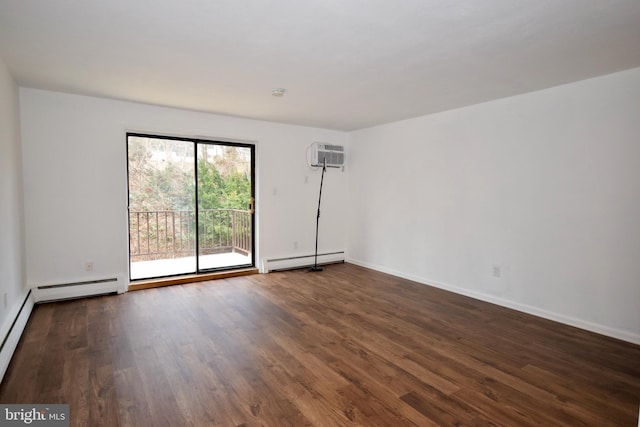 spare room with an AC wall unit, baseboard heating, wood finished floors, and baseboards