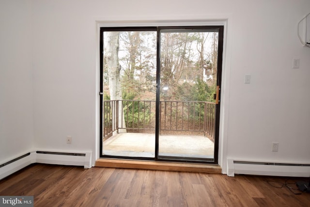 entryway featuring a baseboard heating unit and wood finished floors