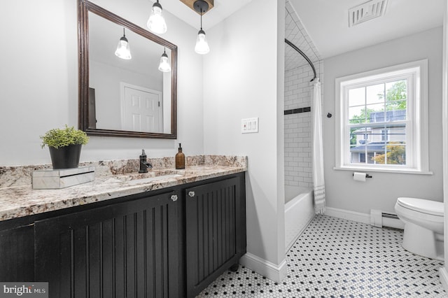 bathroom featuring visible vents, baseboard heating, toilet, vanity, and baseboards