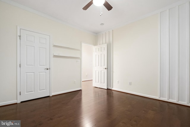 unfurnished bedroom with dark wood finished floors, a ceiling fan, and baseboards