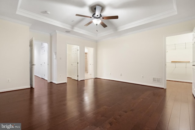 interior space featuring dark wood finished floors, ceiling fan, visible vents, and ornamental molding