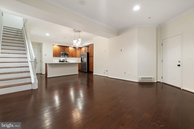 unfurnished living room with ornamental molding, a baseboard heating unit, dark wood-style floors, recessed lighting, and stairs