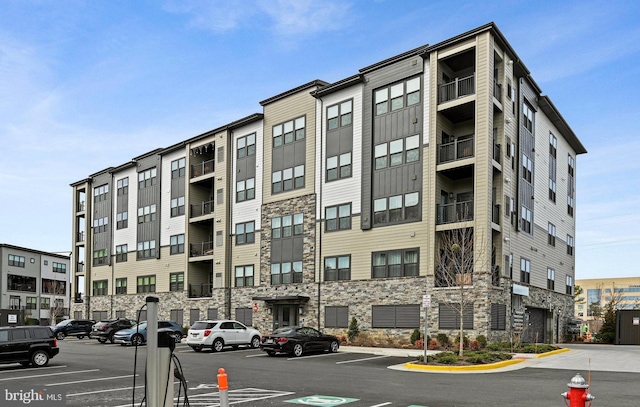 view of property featuring uncovered parking