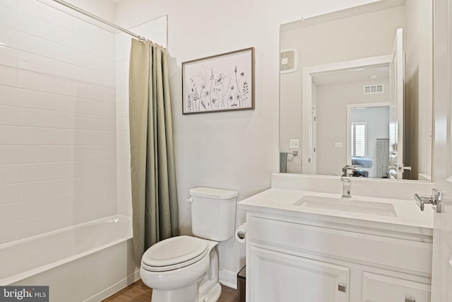 full bath featuring toilet, wood finished floors, vanity, visible vents, and shower / bath combo