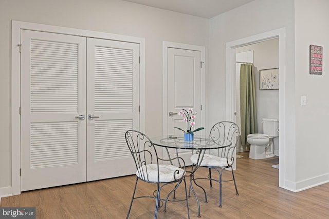 dining area featuring baseboards and wood finished floors