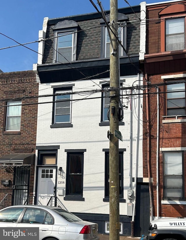 multi unit property with brick siding and mansard roof