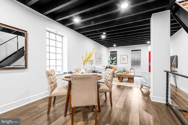 dining room featuring recessed lighting, beam ceiling, baseboards, and wood finished floors