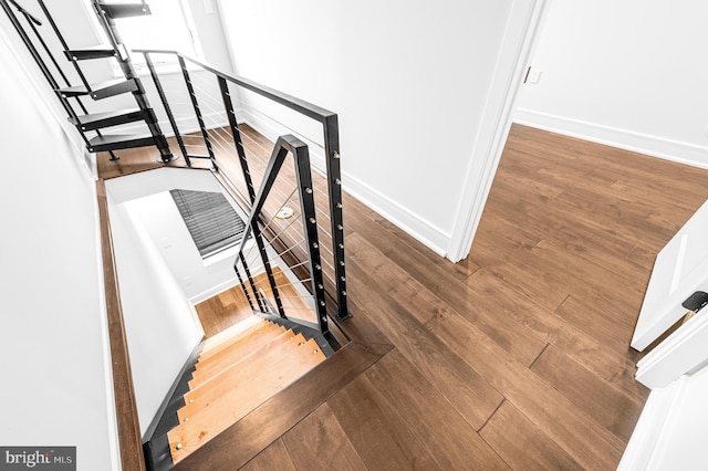 stairs with baseboards and wood finished floors