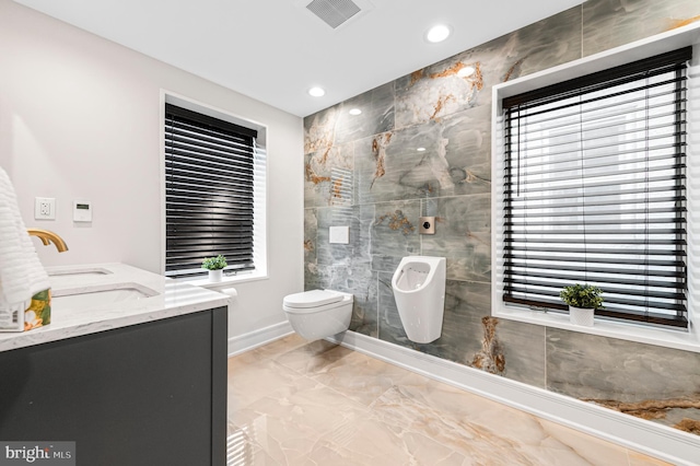 full bathroom featuring marble finish floor, visible vents, toilet, a sink, and baseboards