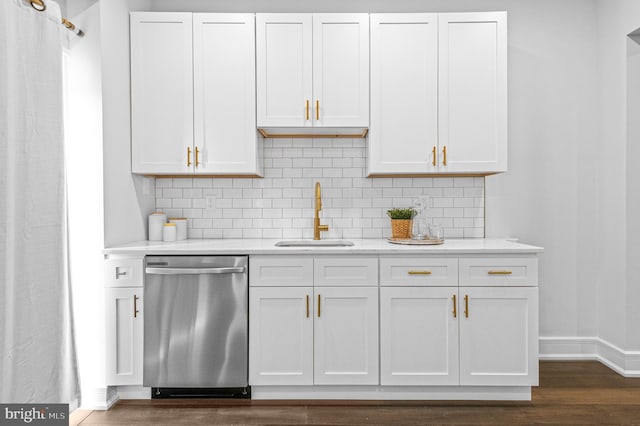 kitchen with decorative backsplash, light countertops, dishwasher, and a sink