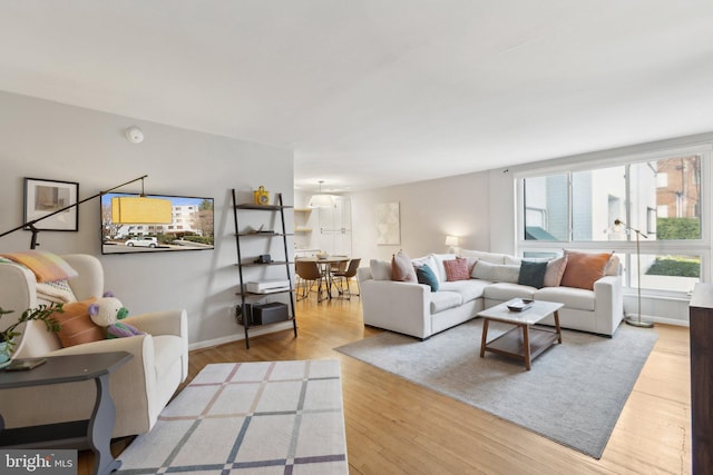 living area featuring baseboards and wood finished floors