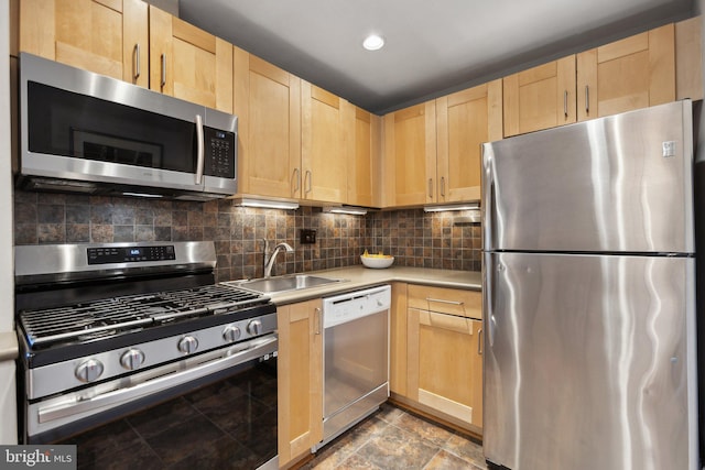 kitchen featuring a sink, appliances with stainless steel finishes, light brown cabinetry, and light countertops