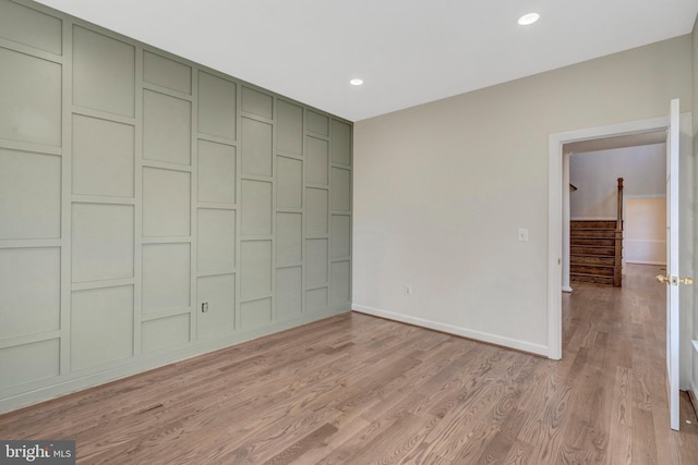 unfurnished bedroom with light wood-style flooring, baseboards, a closet, and recessed lighting