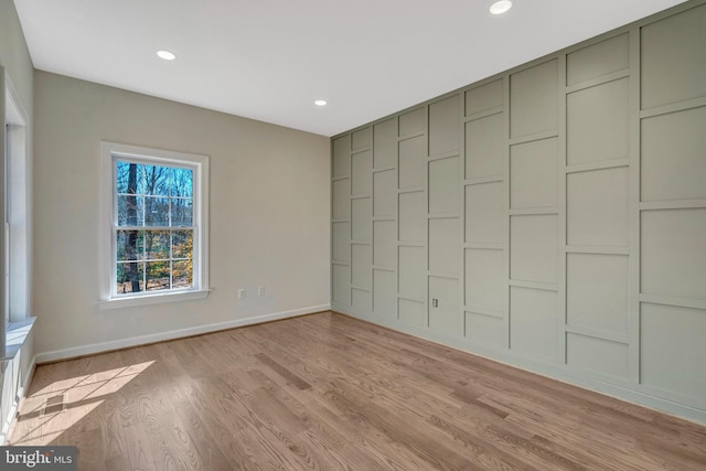 unfurnished room featuring light wood-type flooring, baseboards, and recessed lighting