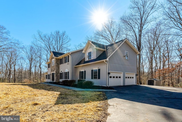 view of front of property featuring aphalt driveway and an attached garage