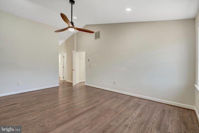 unfurnished room featuring a ceiling fan, baseboards, visible vents, and wood finished floors