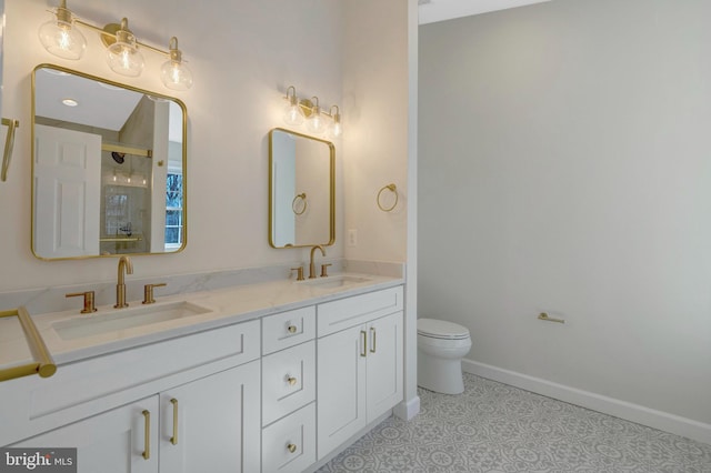 bathroom with baseboards, double vanity, a sink, and a shower stall