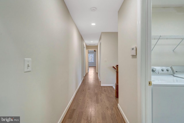 hall with recessed lighting, an upstairs landing, washer and dryer, baseboards, and light wood finished floors