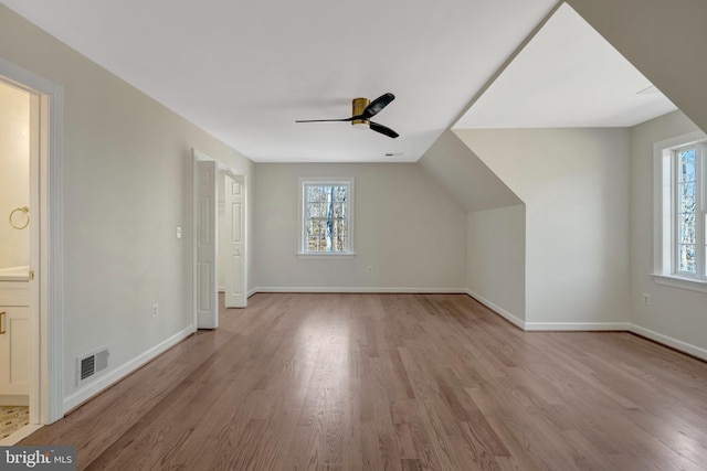 additional living space featuring ceiling fan, wood finished floors, visible vents, and baseboards