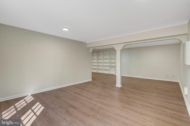 below grade area featuring light wood-style floors and baseboards